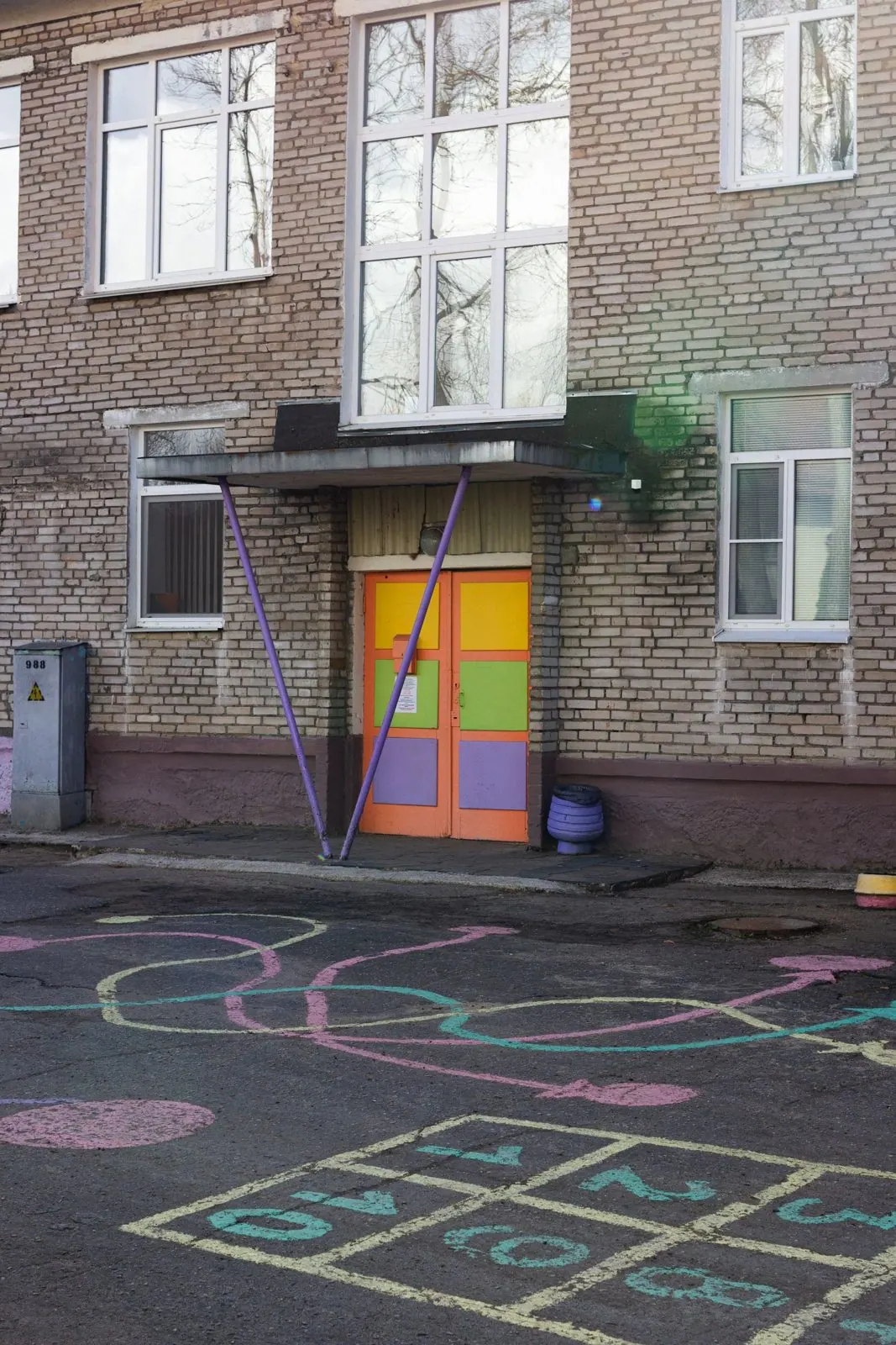 At a school, high on a wall beside the playground